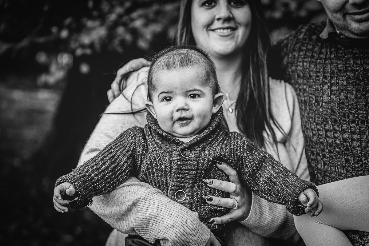 Picture of baby being held by mum during family portrait session in Dorset
