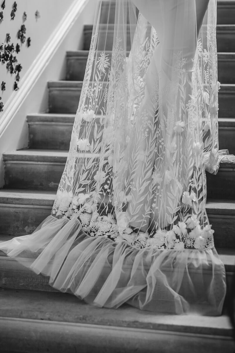 Close up of Brides Dress walking up the stairs at Came House