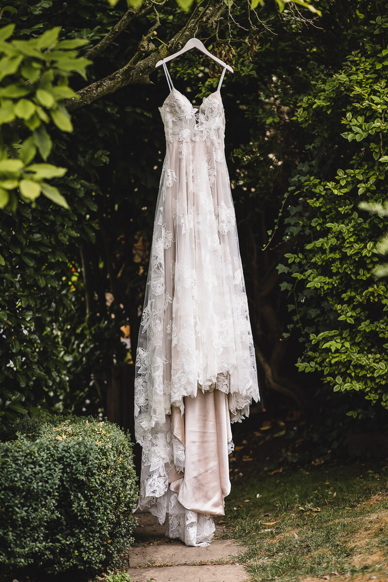 Brides dress hanging from a tree